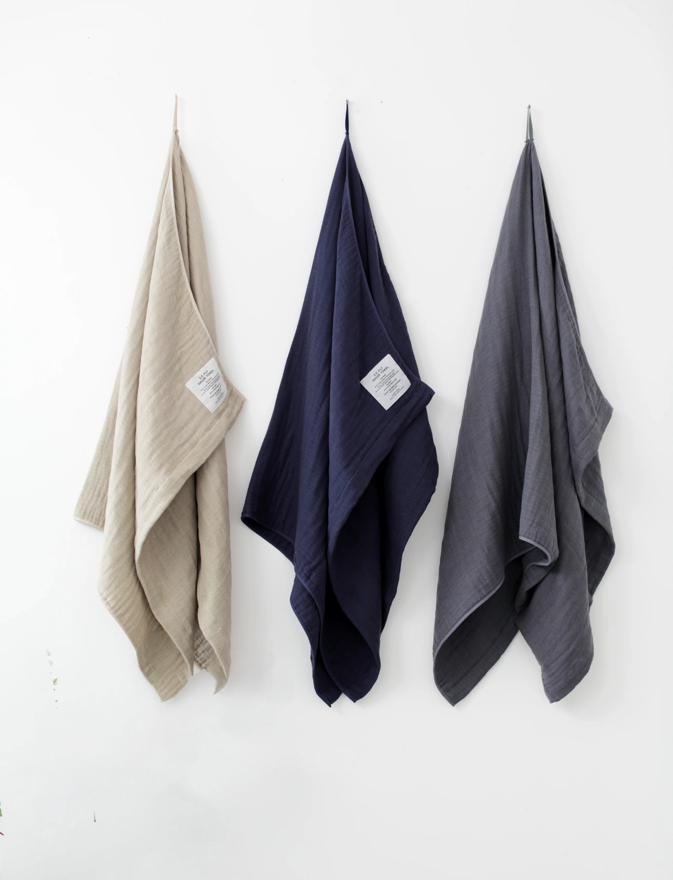 Three Shinto towels hanging on a white wall 