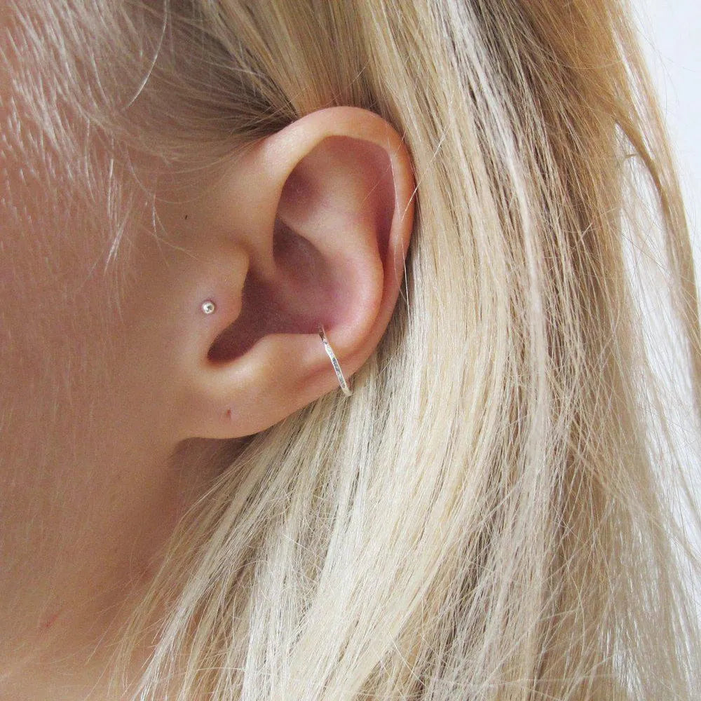 women with blonde hair wearing silver on her ear