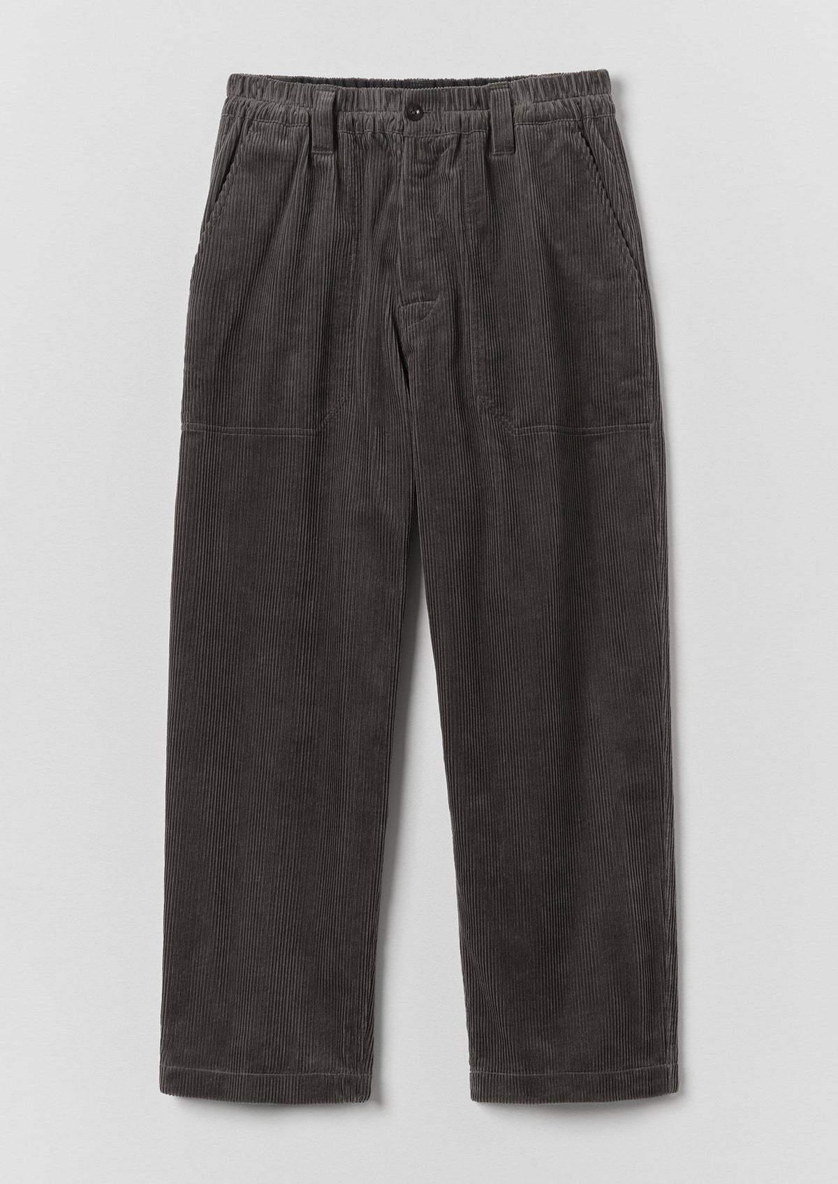 Dark charcoal gray corduroy trousers with an elastic waistband and front patch pockets, shown flat on a light grey background.