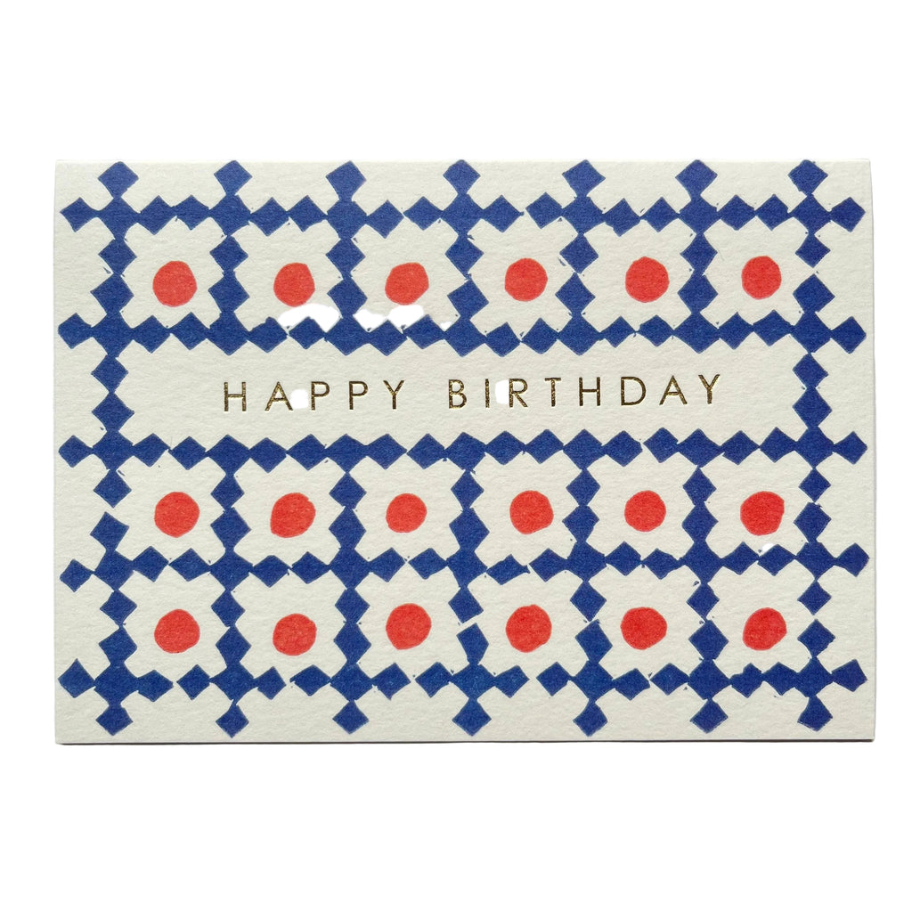 Birthday card with blue and red pattern and 'Happy Birthday' text on a gray background