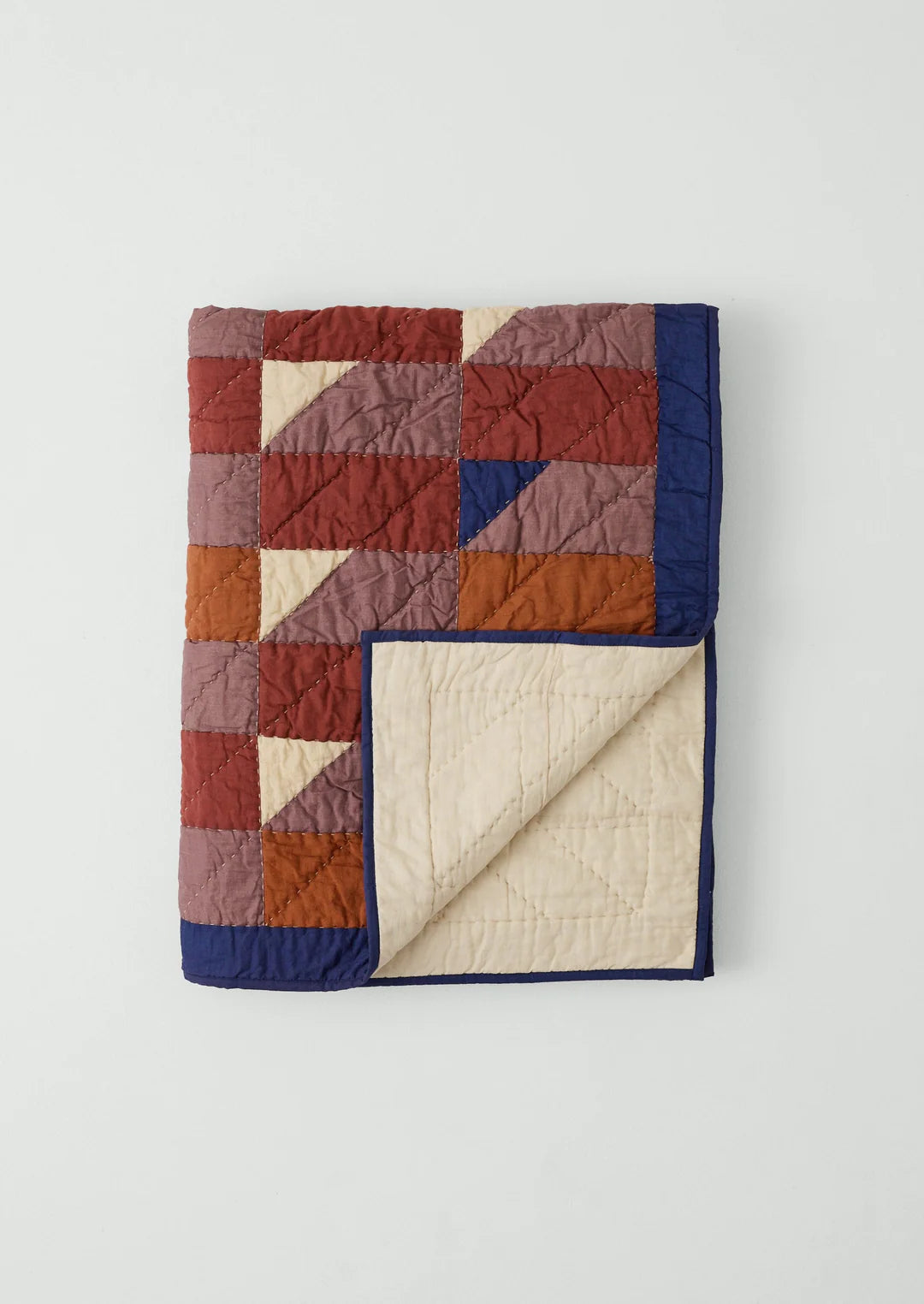 Quilt with a patchwork pattern on a white background