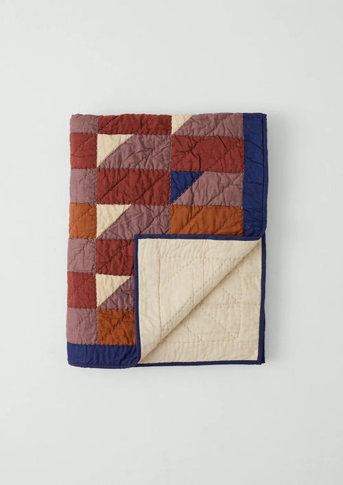 Quilt with a patchwork pattern on a white background