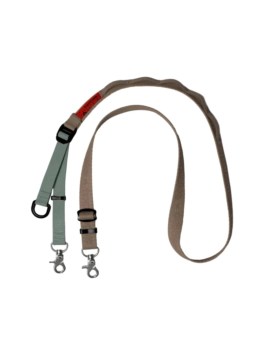 Topologie Phone or Bag Strap in green and beige sections on a white  background