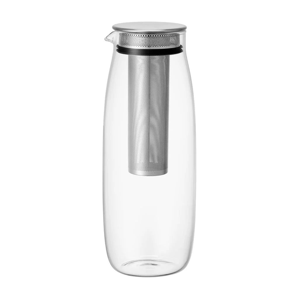 Clear glass carafe with metal infuser on a white background