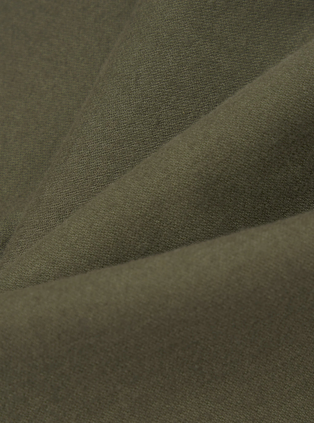 A close-up of draped olive green moleakin fabric with a fine woven texture.