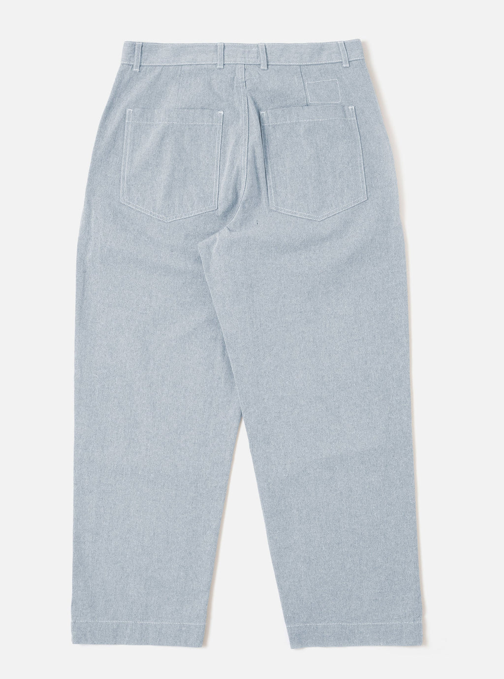 Universal Works Light denim Duke Pants against a white background. 