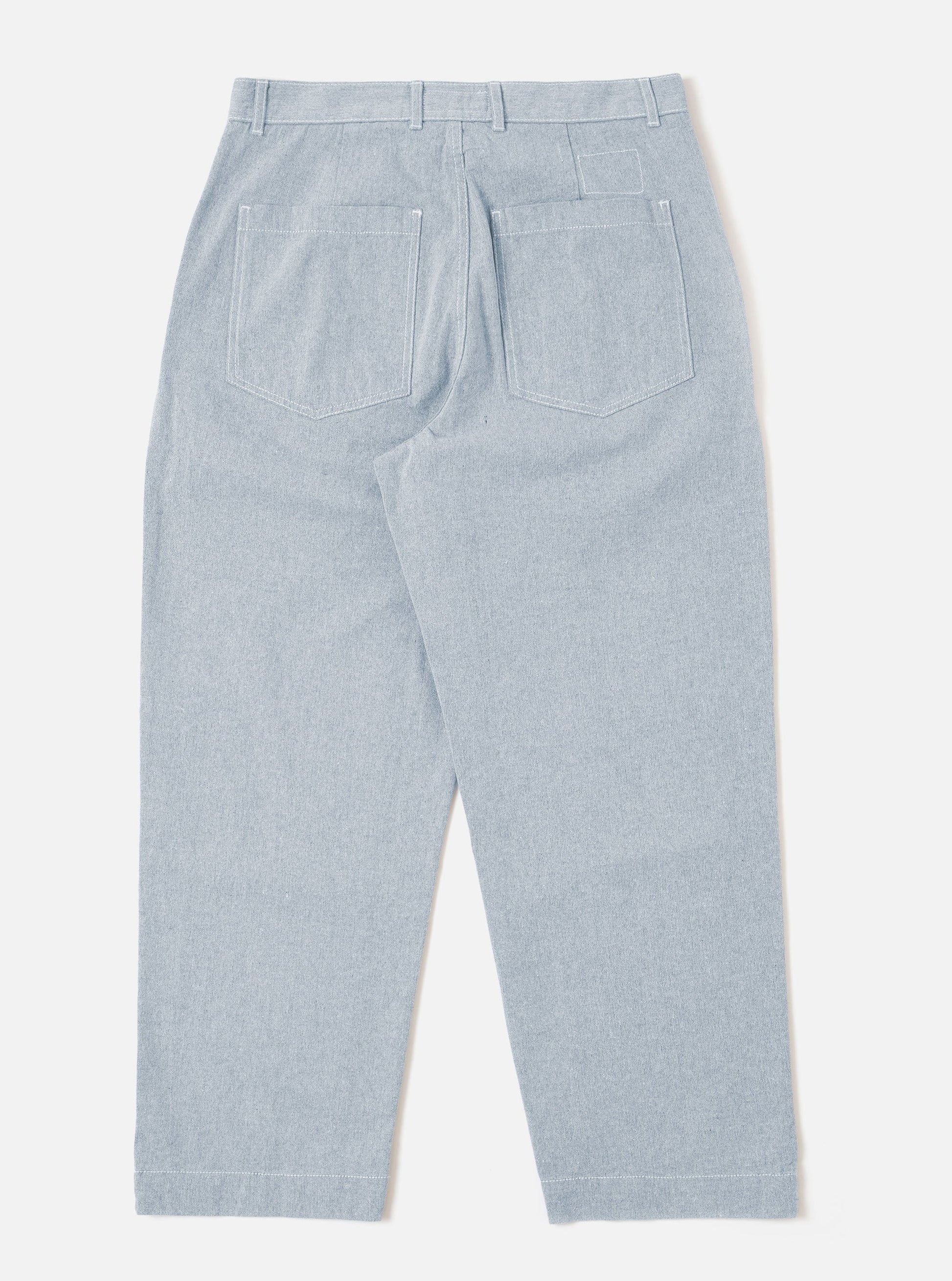 Universal Works Light denim Duke Pants against a white background. 