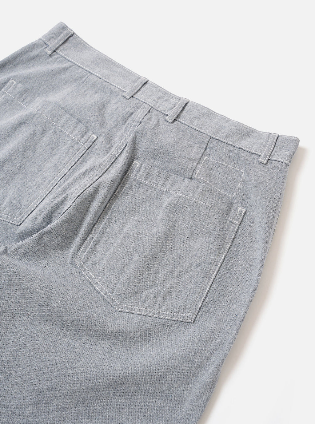 Universal Works light blue denim Duke pant against a white background. 
