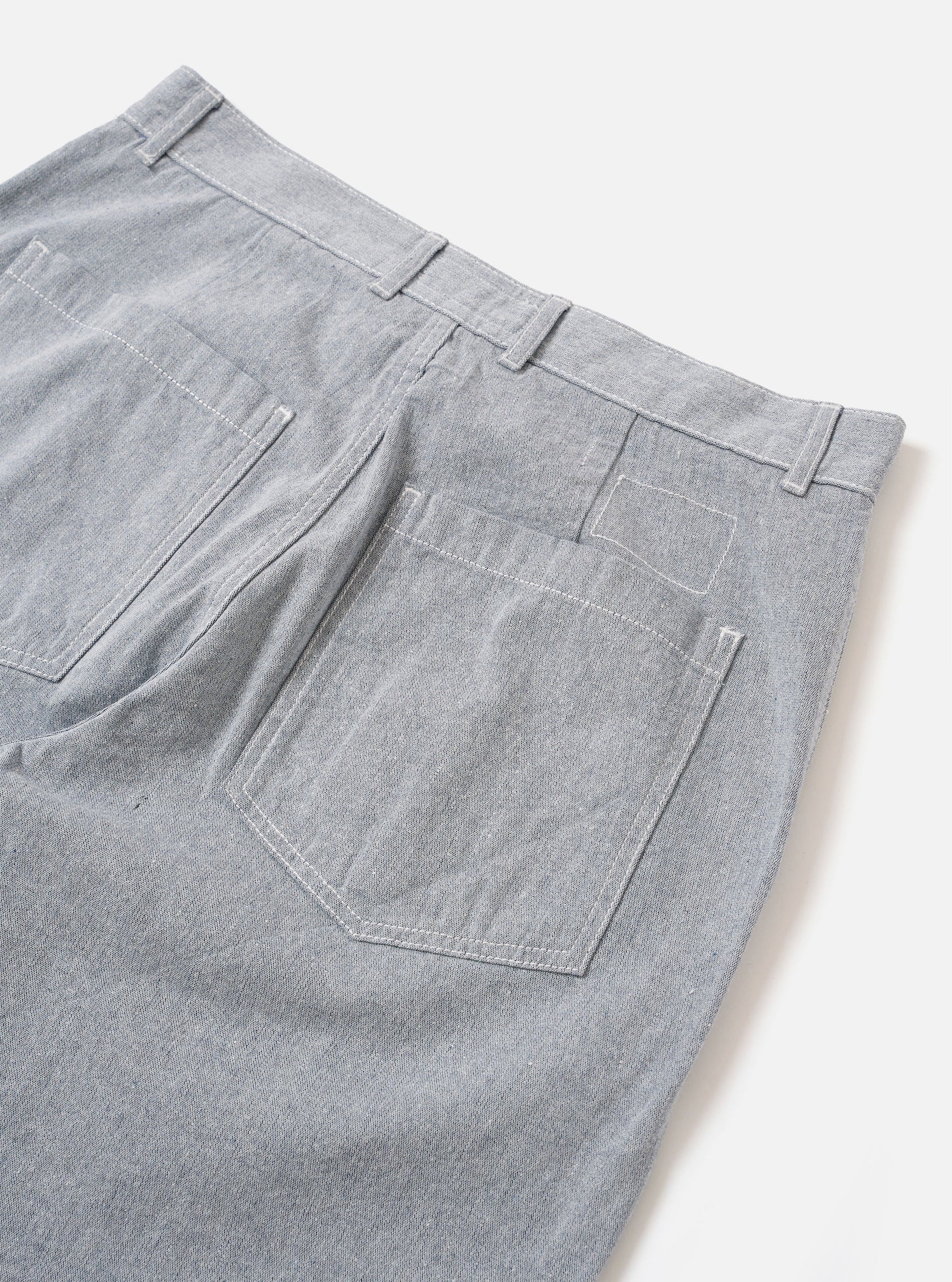Universal Works light blue denim Duke pant against a white background. 