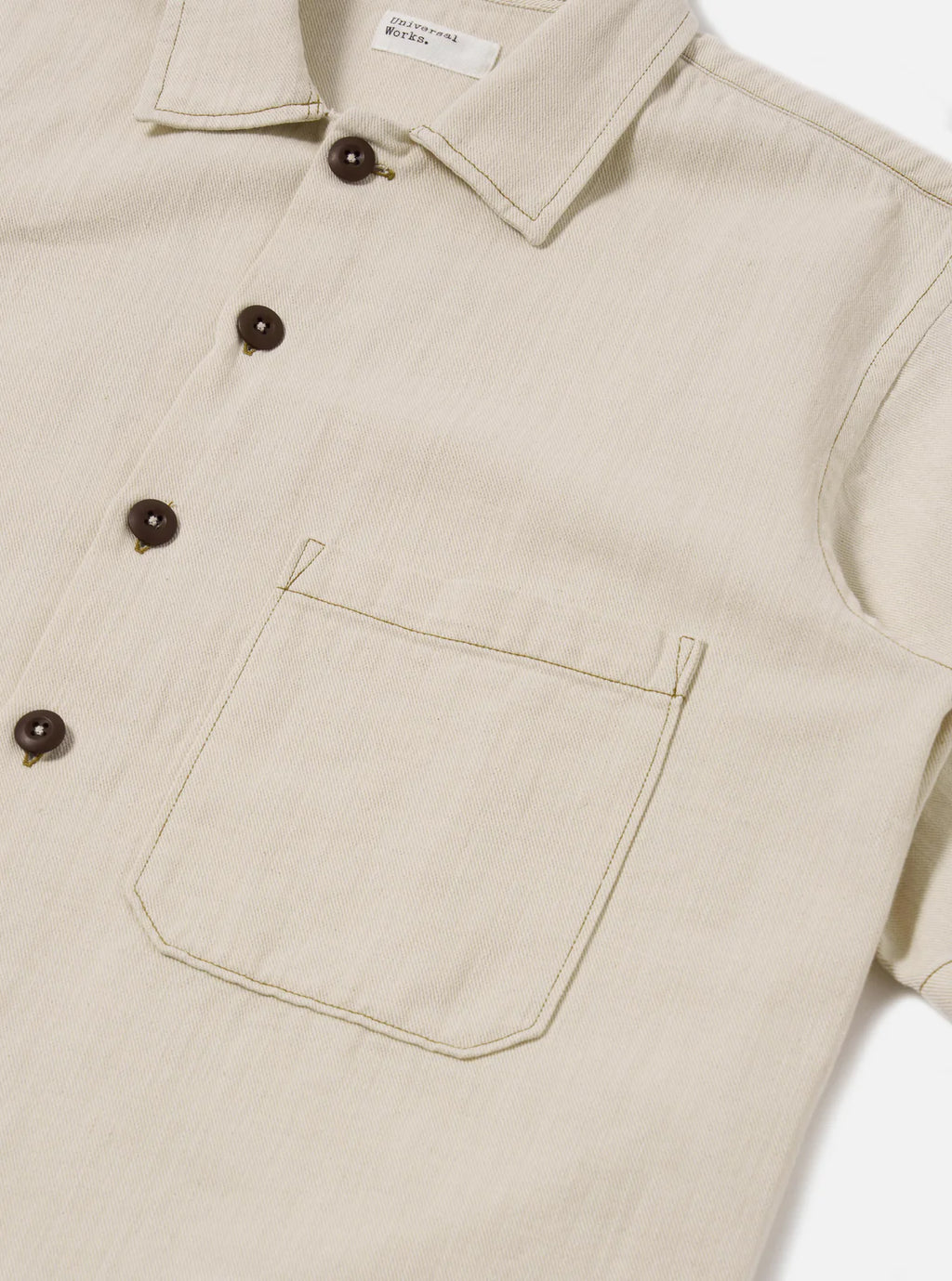 Beige shirt  with button details on a white background