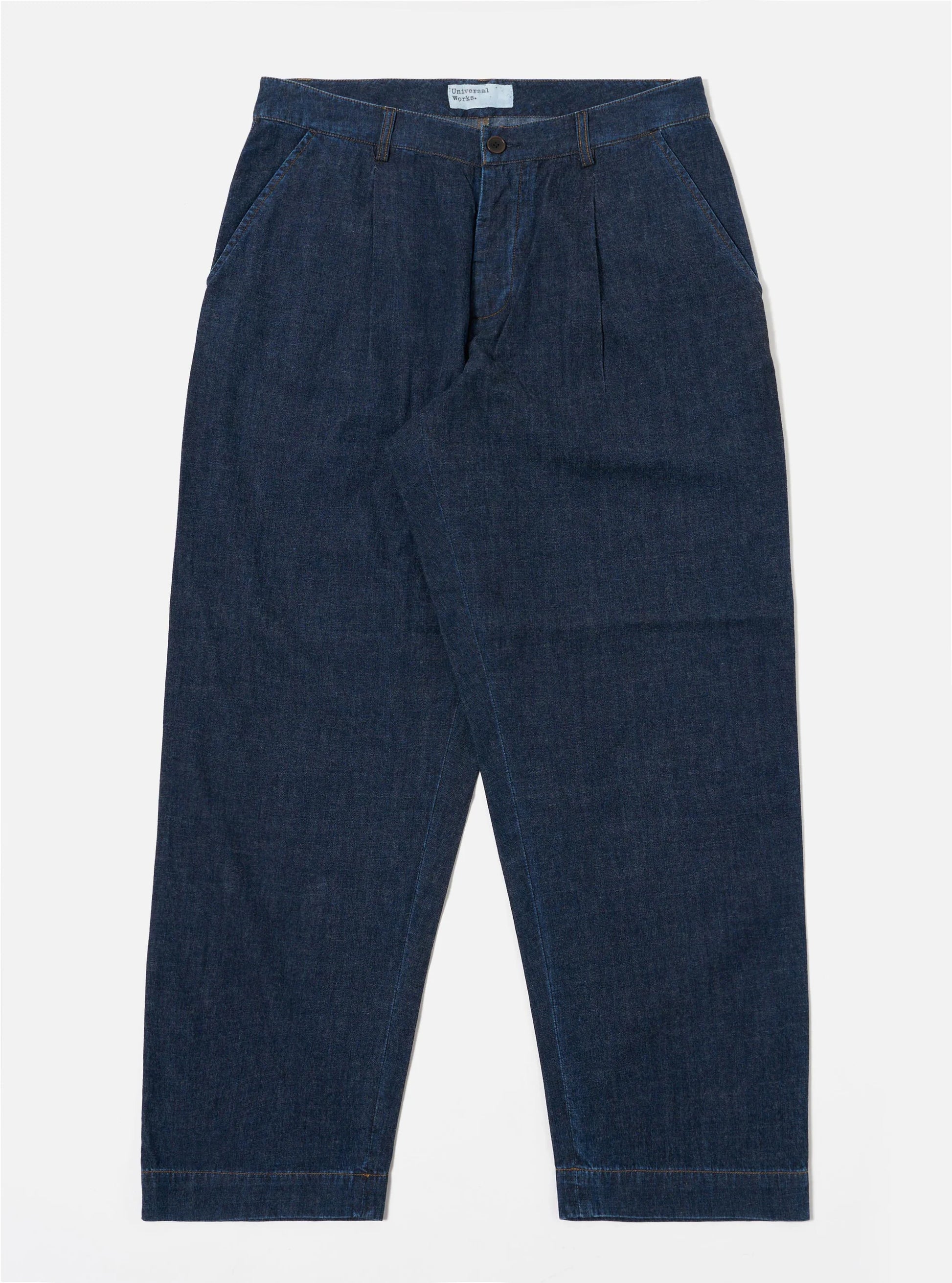 Universal Works Indigo Denim Duke Trousers against a white background.