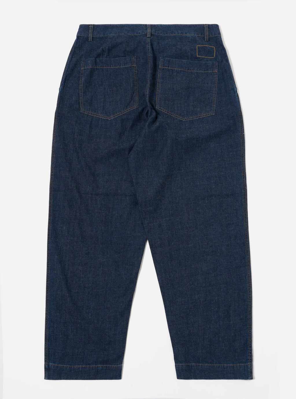 Universal Works Indigo Duke trousers against a white background 