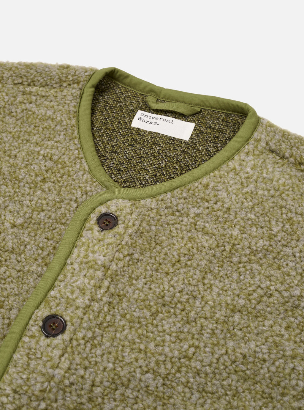 Close up the neckline and buttons  of the Universal Works Lancaster Olive coloured Gilet 