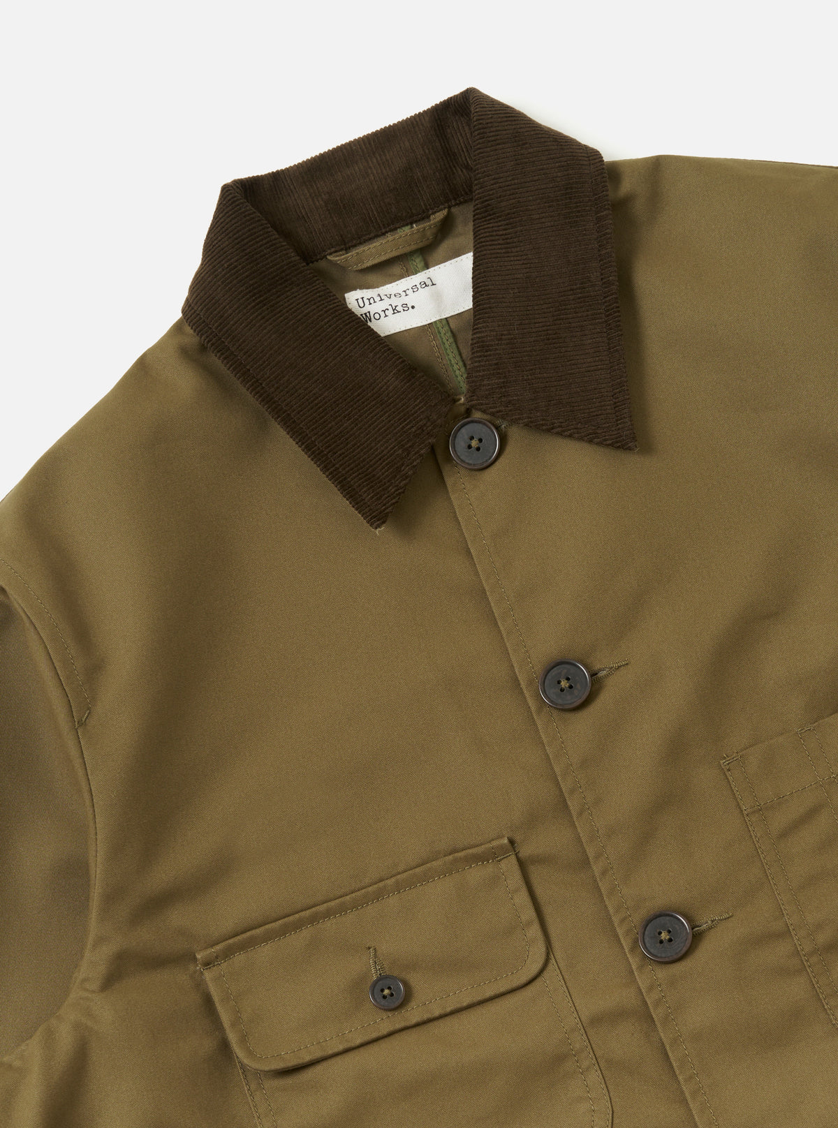Universal Works khaki jacket with a brown collar and buttons on a white background