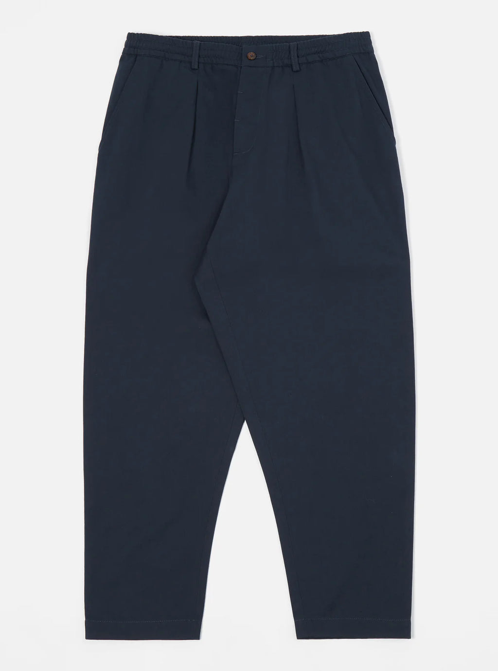 Universal Works navy blue pleated trousers on a white background