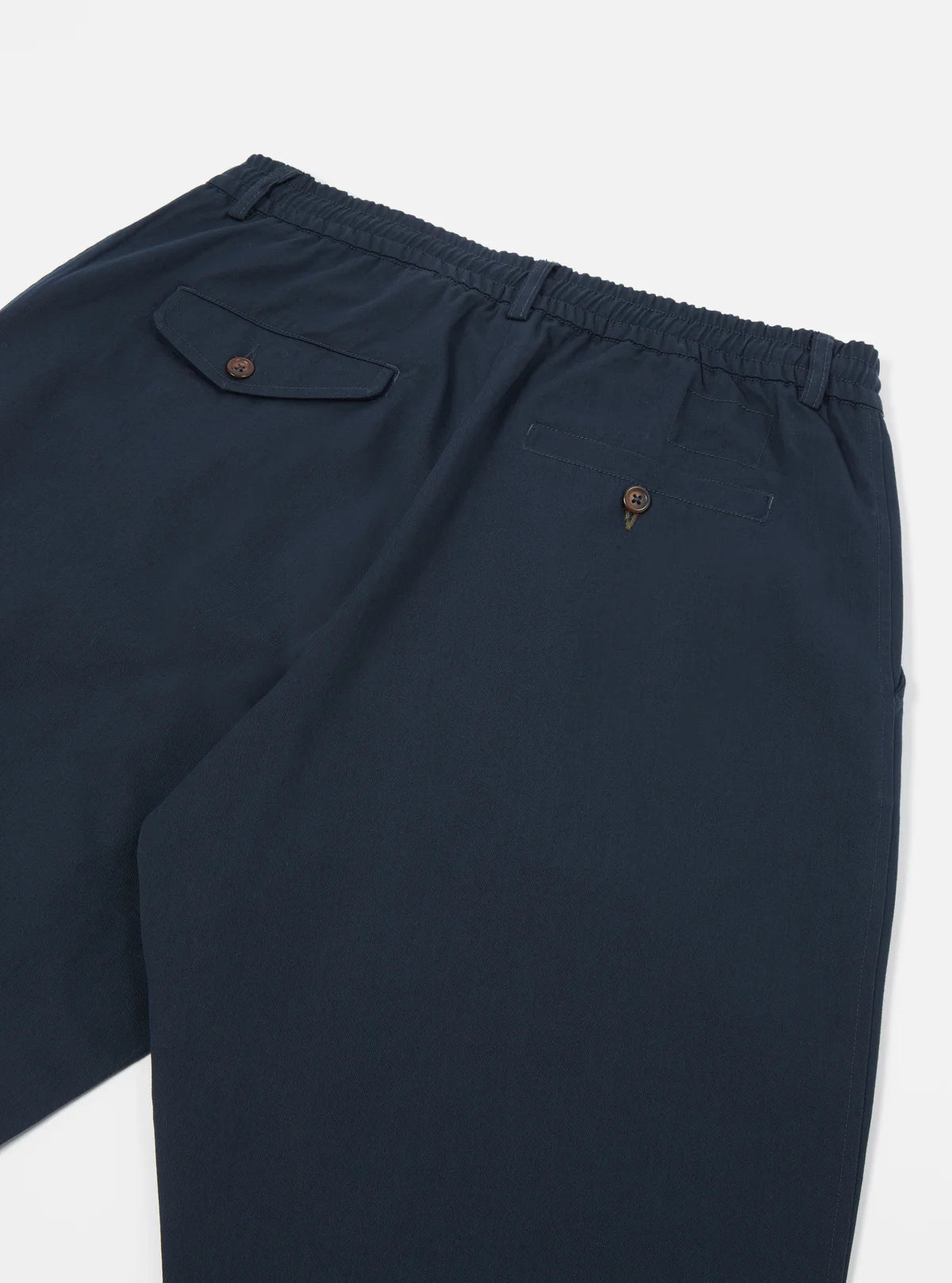 Universal Works navy blue trousers with a pocket on a white background