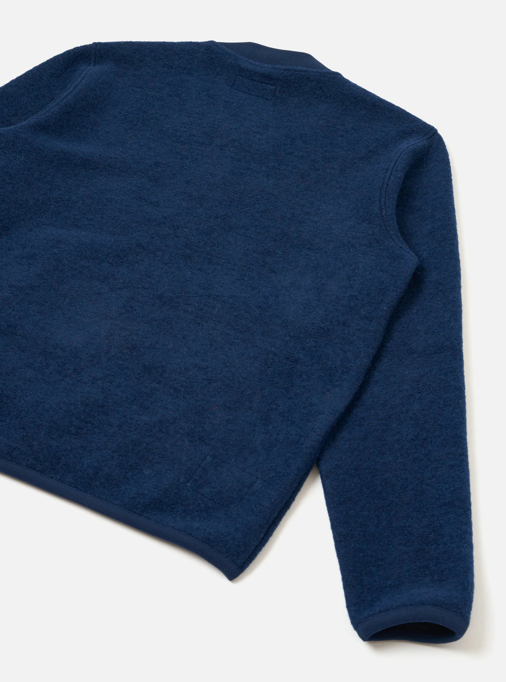 Universal Works Indigo wool fleece Bomber jacket image showing the back of the jacket against a light grey background 