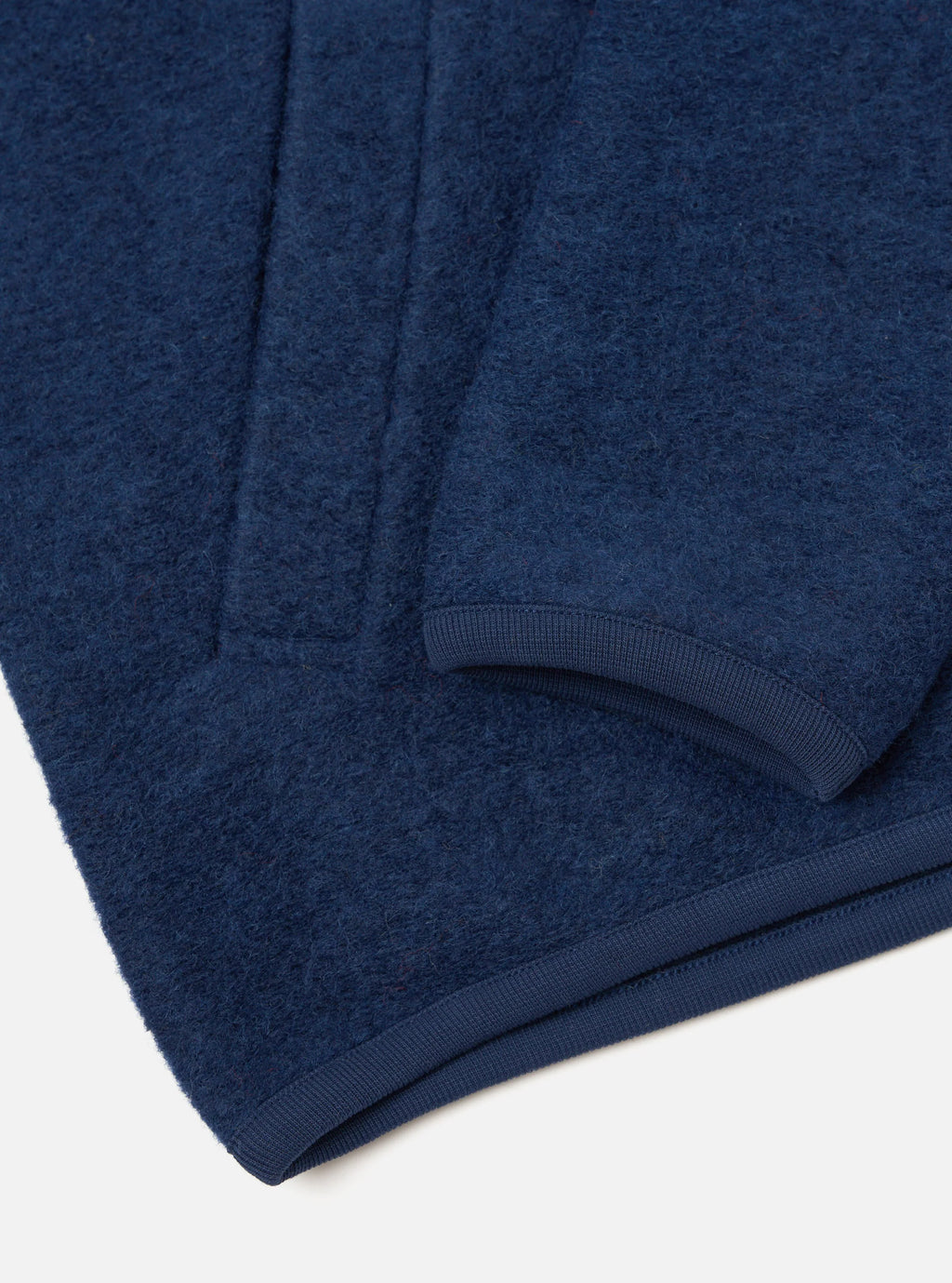 Close detail of the sleeve of the Universal Works  indigo zip bomber 