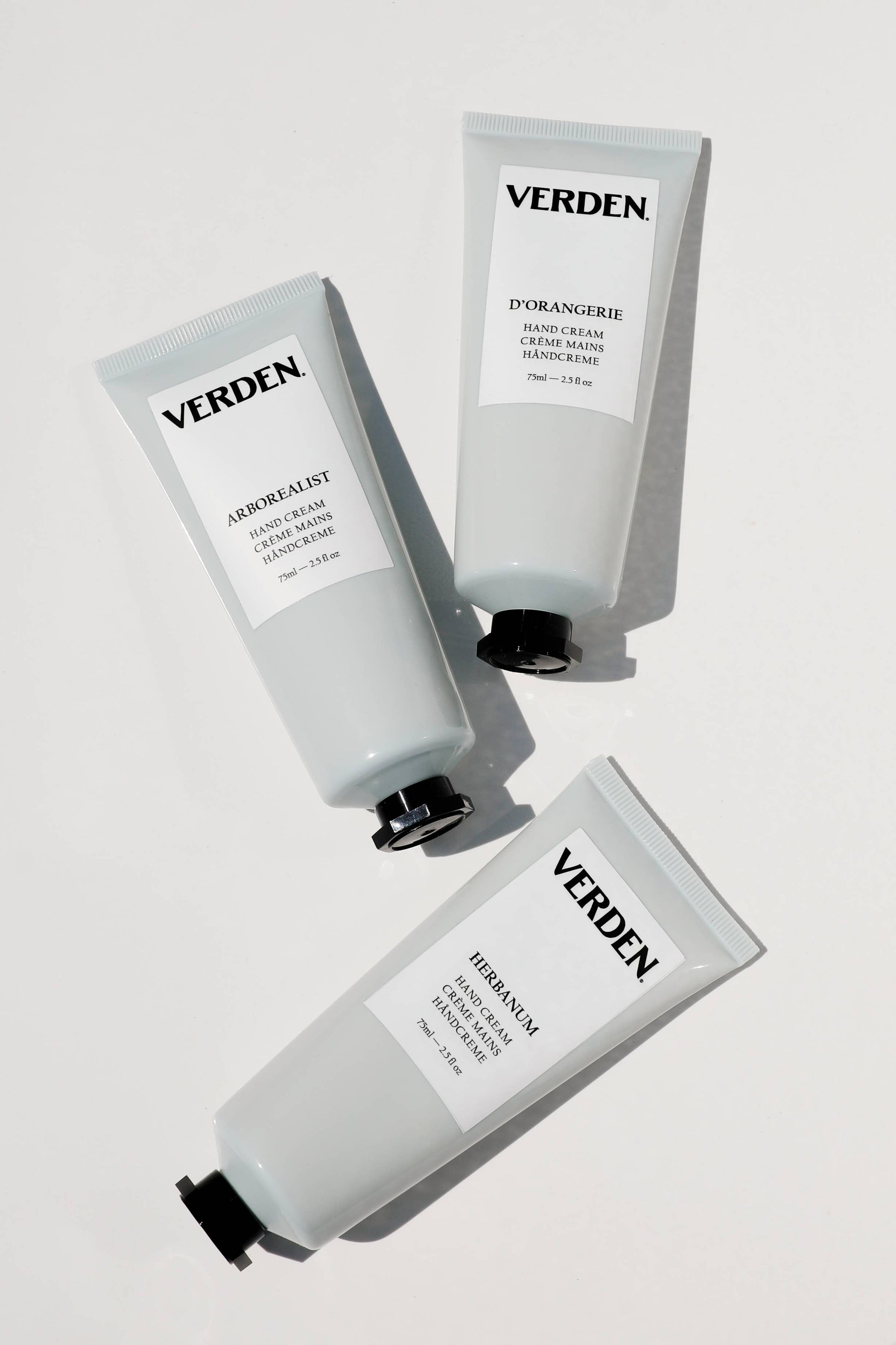 Three tubes of Verden skincare products on a light gray background