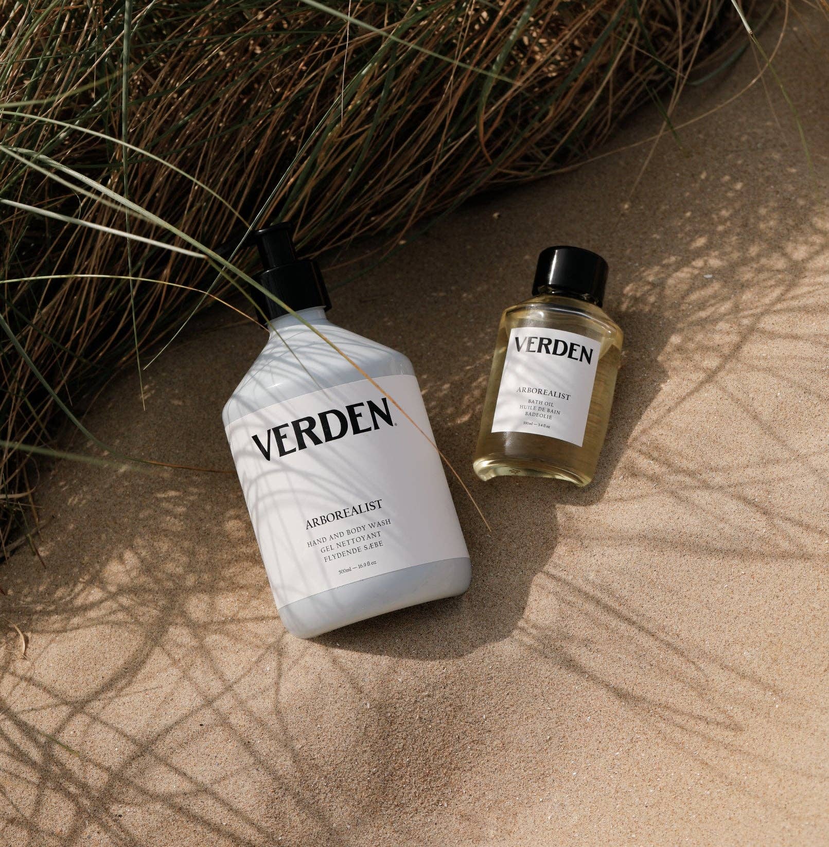 Two Verden bottles on a textured surface with natural elements.