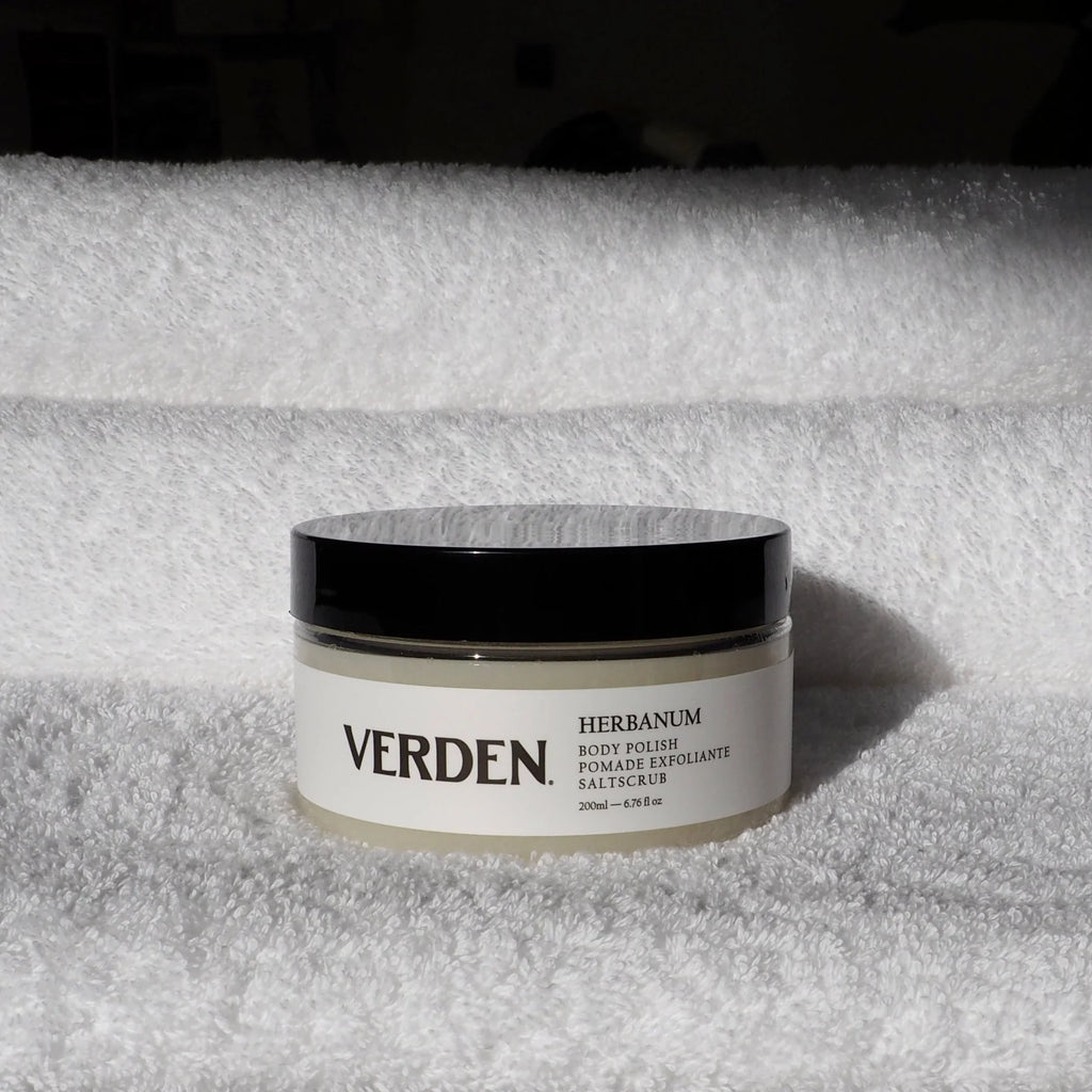 Verden body polish jar on a textured white surface