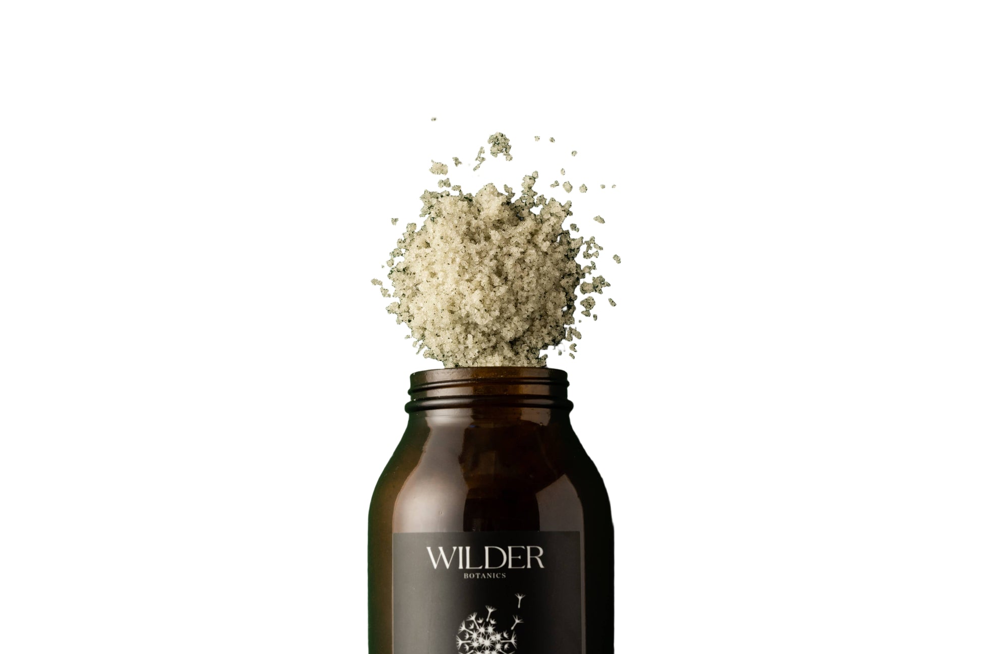 Bottle of Wilder Botanics Herbal Tranquility Soak with salts  spilling out on a white  background