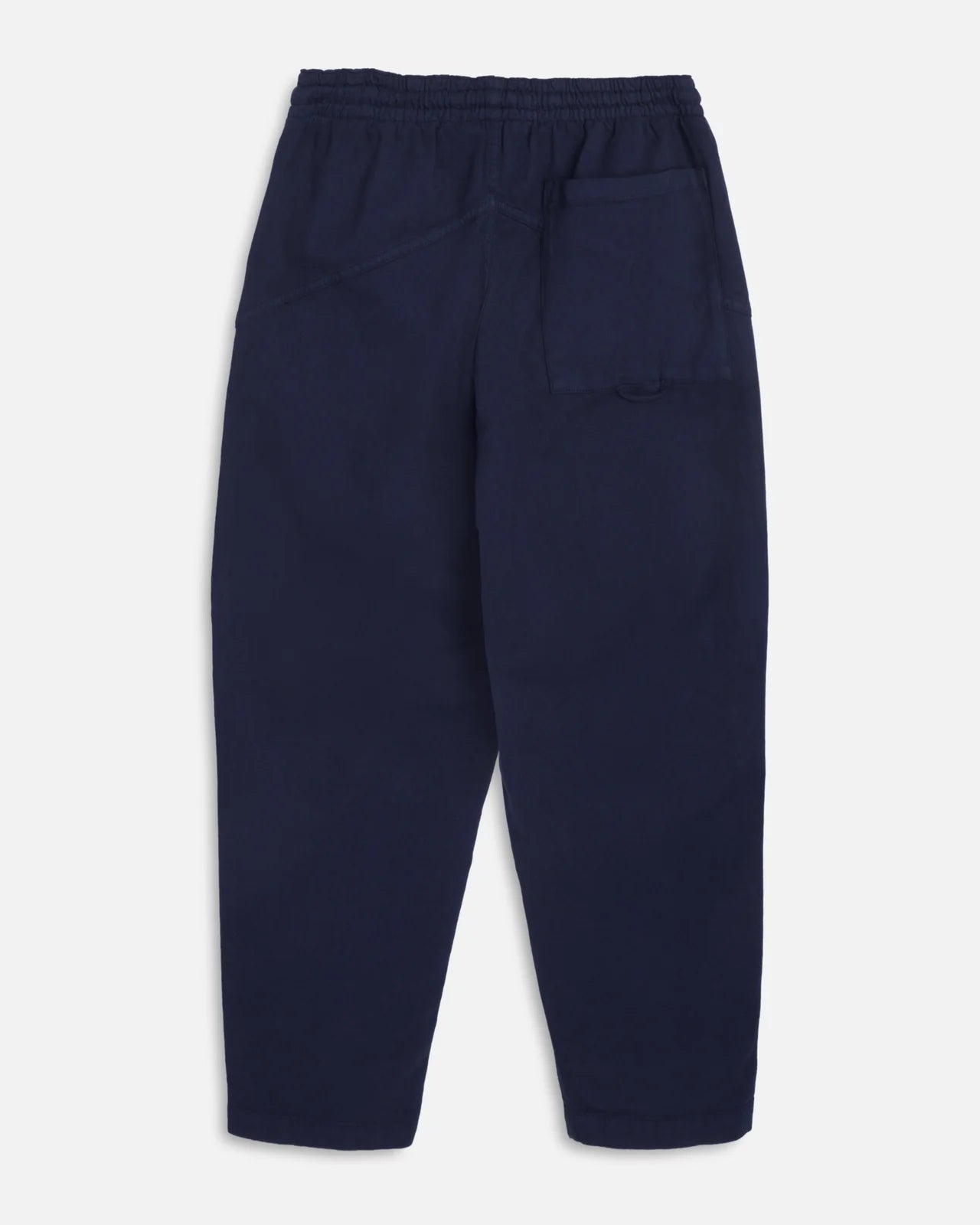 A pair of navy blue You Must Create Alva Skate trousers with an elastic waistband and drawstring, shown flat against a light grey background.