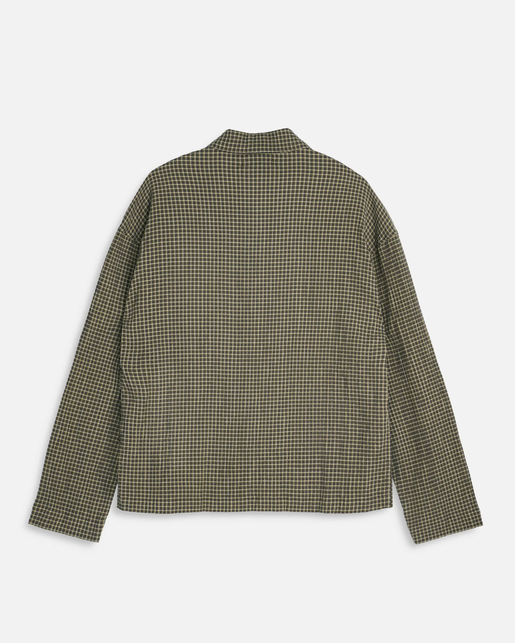 A long-sleeve YMC PJ button-up over shirt with a small-scale green and beige checkered pattern, shown from the back on a light gray background.