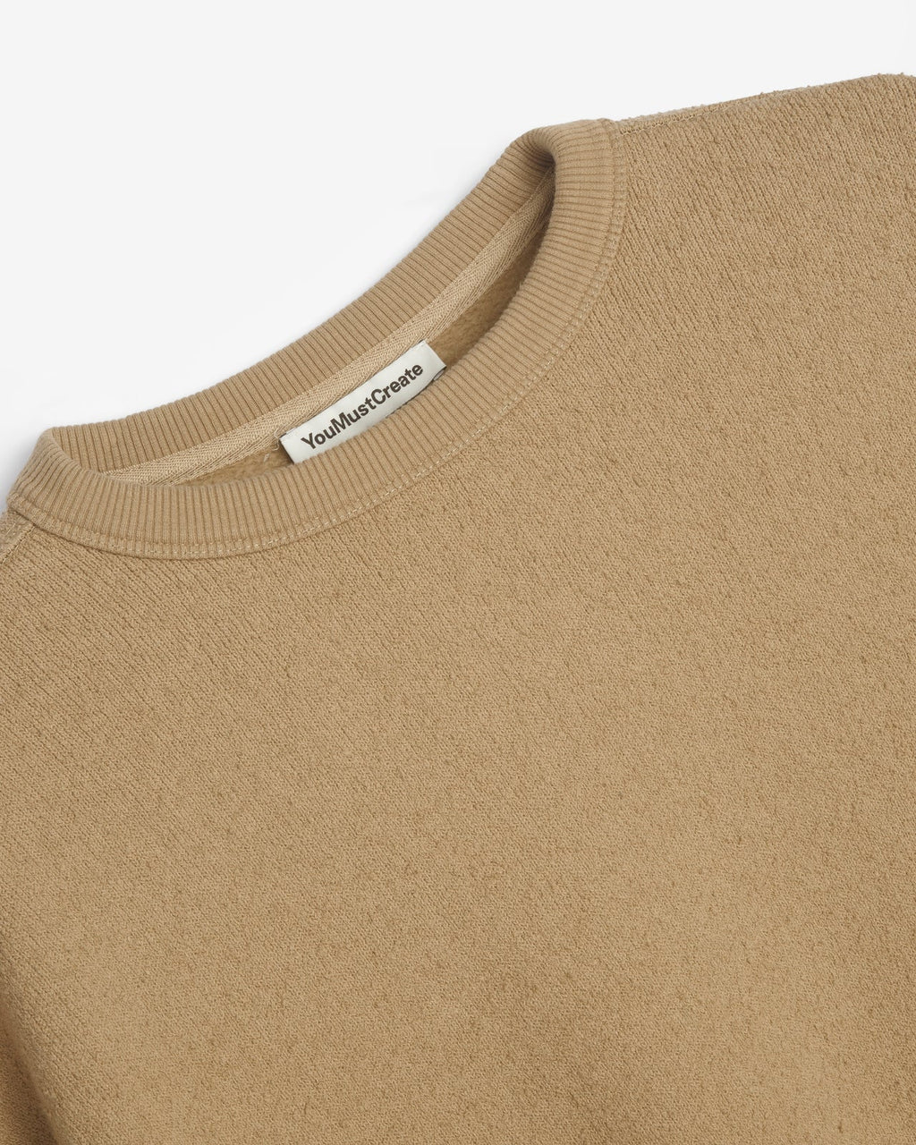 You Must Create taupe crewneck sweatshirt with a raw, frayed hem and oversized long sleeves, laid flat against a white background.