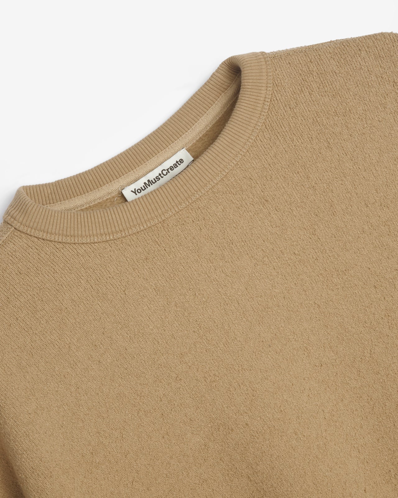 You Must Create taupe crewneck sweatshirt with a raw, frayed hem and oversized long sleeves, laid flat against a white background.