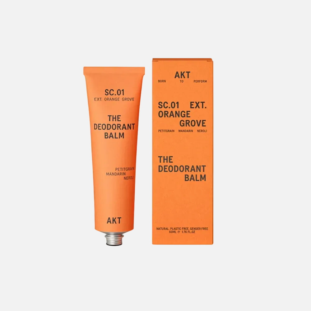 Orange Grove deodorant balm tube and packaging on a beige background