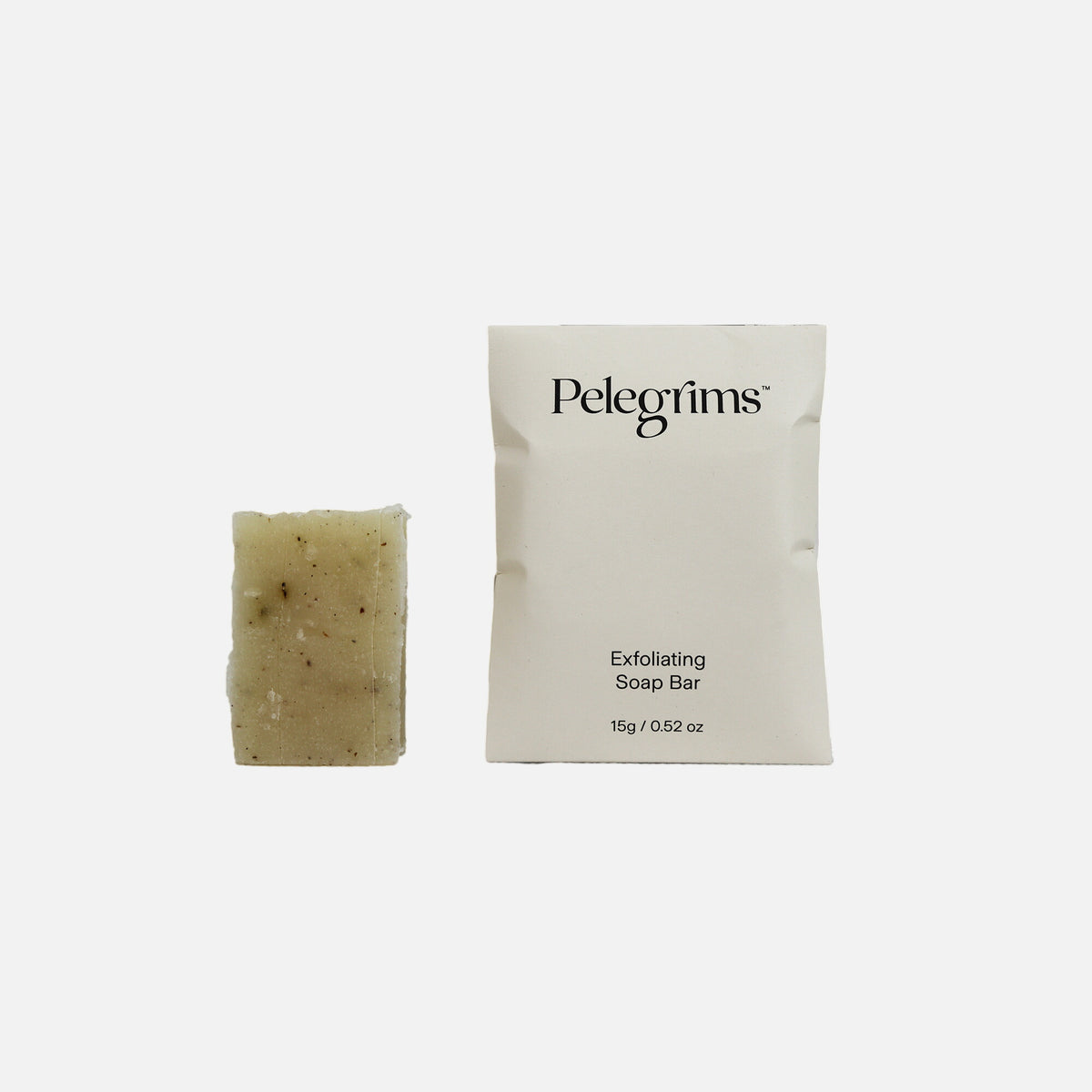 Exfoliating soap bar and packaging with 'Pelegrims' branding on a white background