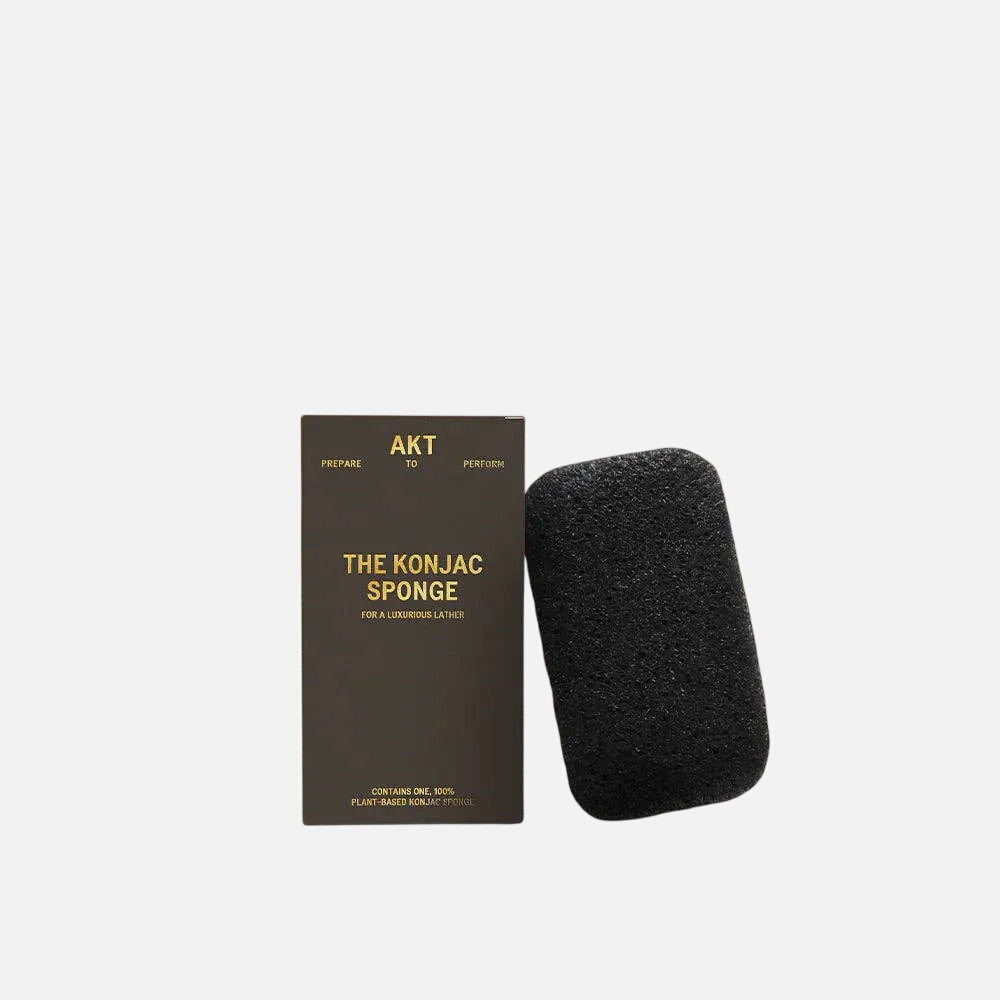 Black Konjac sponge with packaging on a white background 