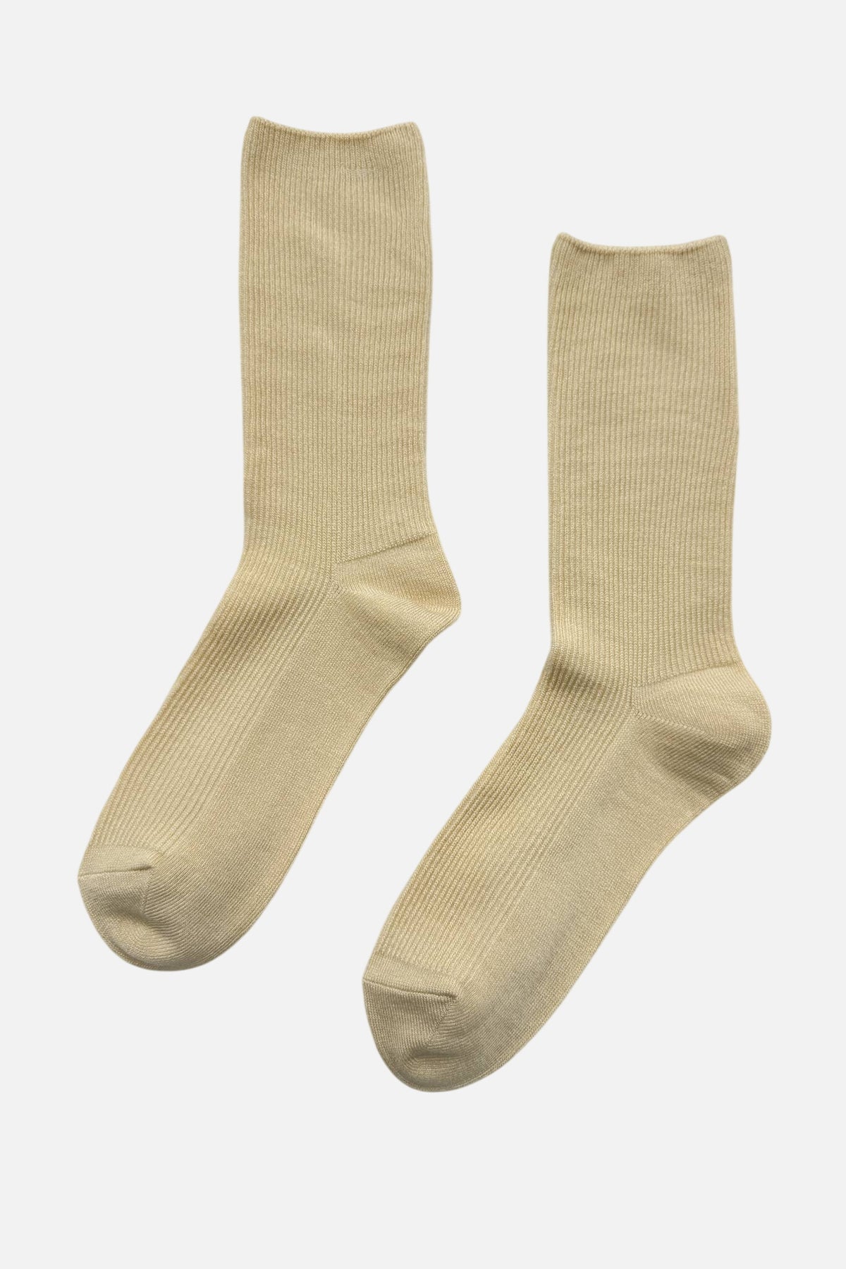 Pair of yellow Le Bon Shoppe socks on a light grey background