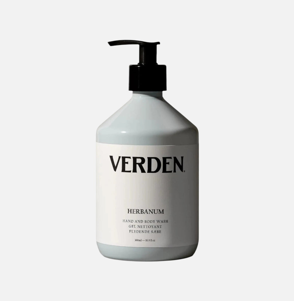 White bottle of Verden Herbanum hand and body wash on a gray background