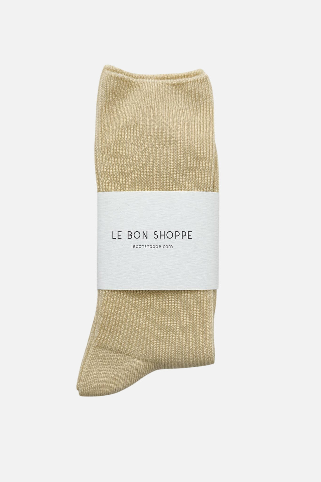 Le Bon Shoppe yellow sock with a white label on a light gray background
