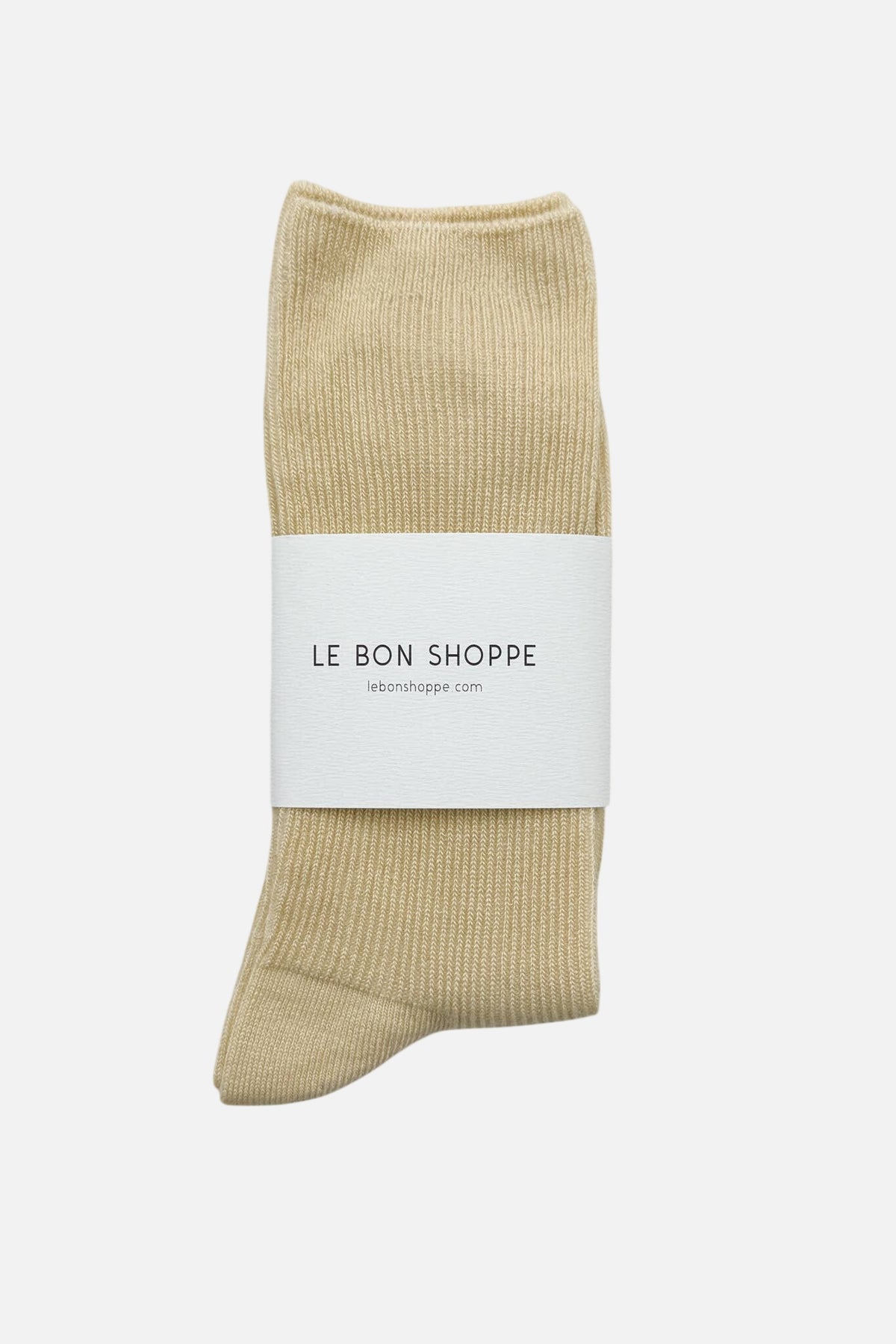 Le Bon Shoppe yellow sock with a white label on a light gray background