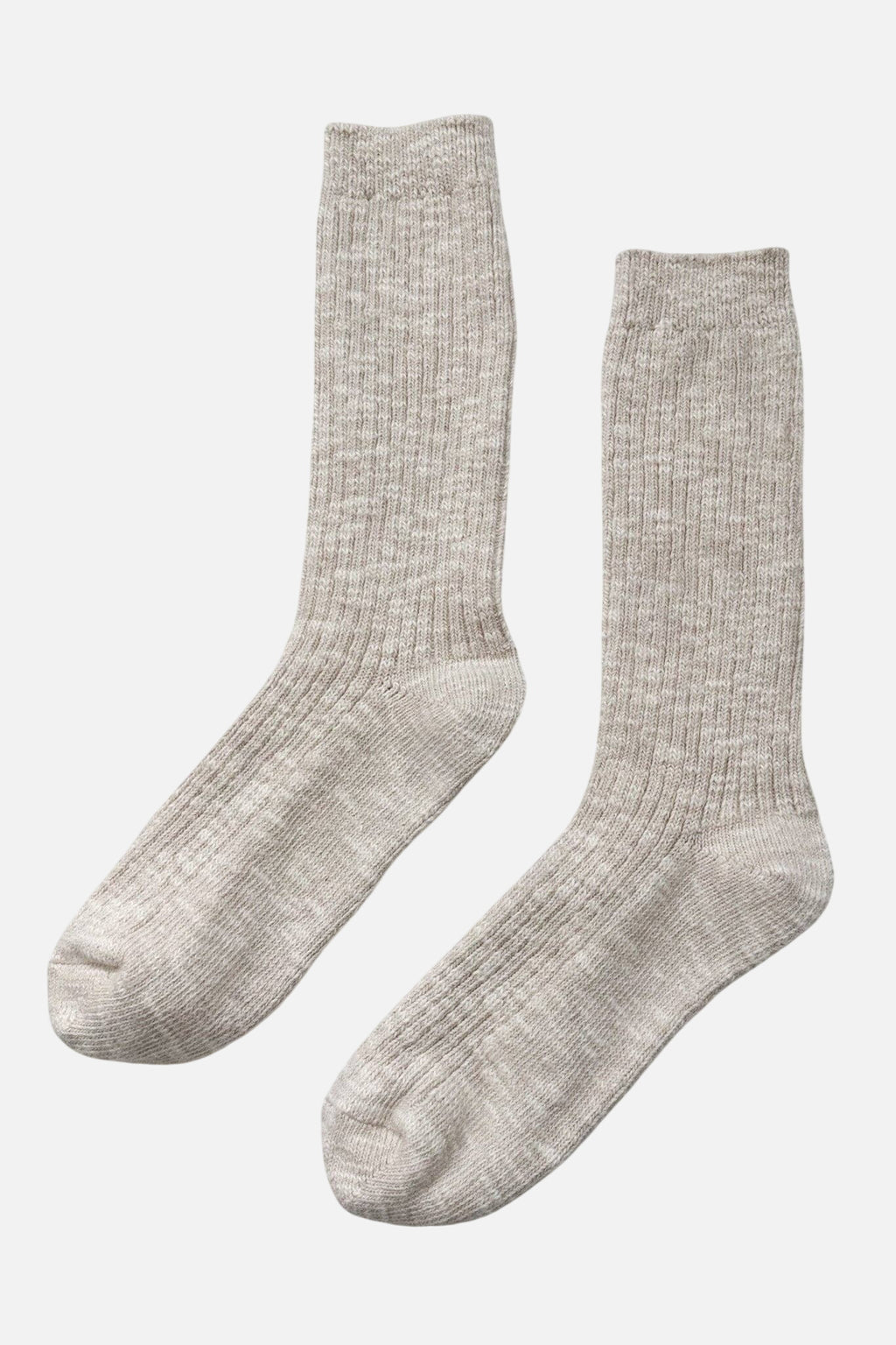 Pair of beige Le Bon Shoppe socks on a light grey background