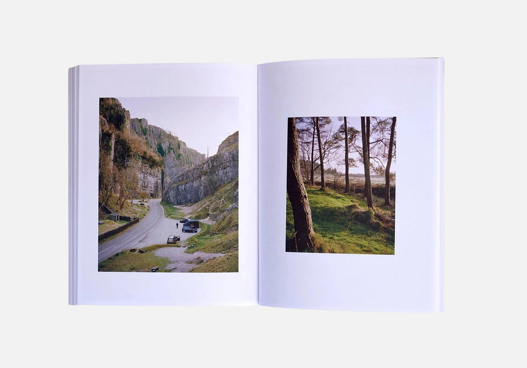 Open book showing two scenic photographs on a white background