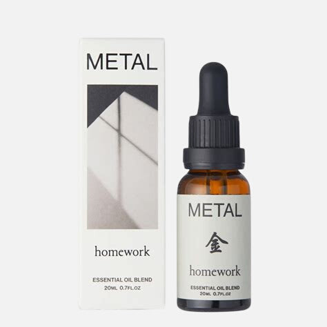 Bottle and box of 'Metal' essential oil blend by 'homework' on a white background