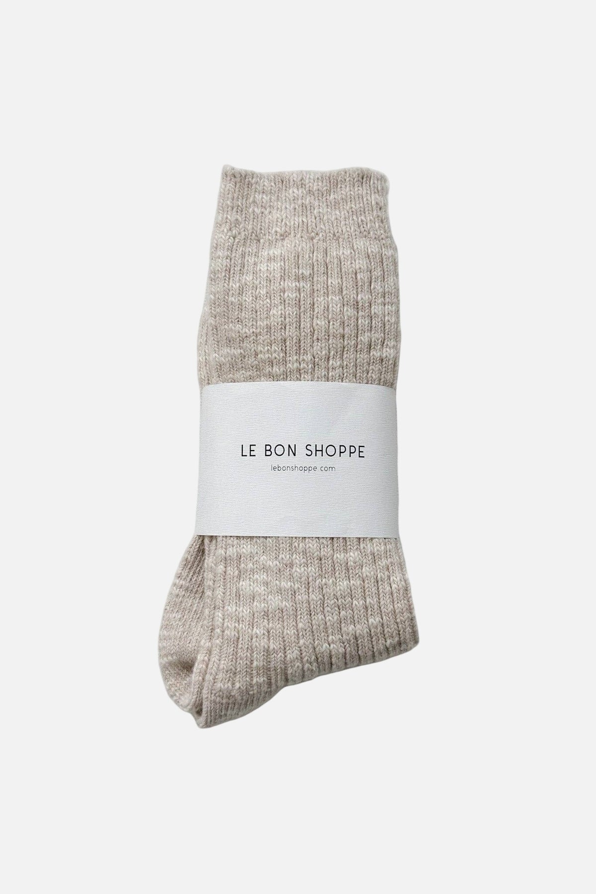 Pair of beige Le Bon Shoppe socks with a white label on a white  background