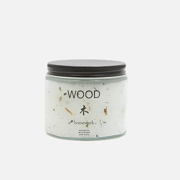 jar labeled 'Wood' by 'homework' on a white background containing white bath salt crystals