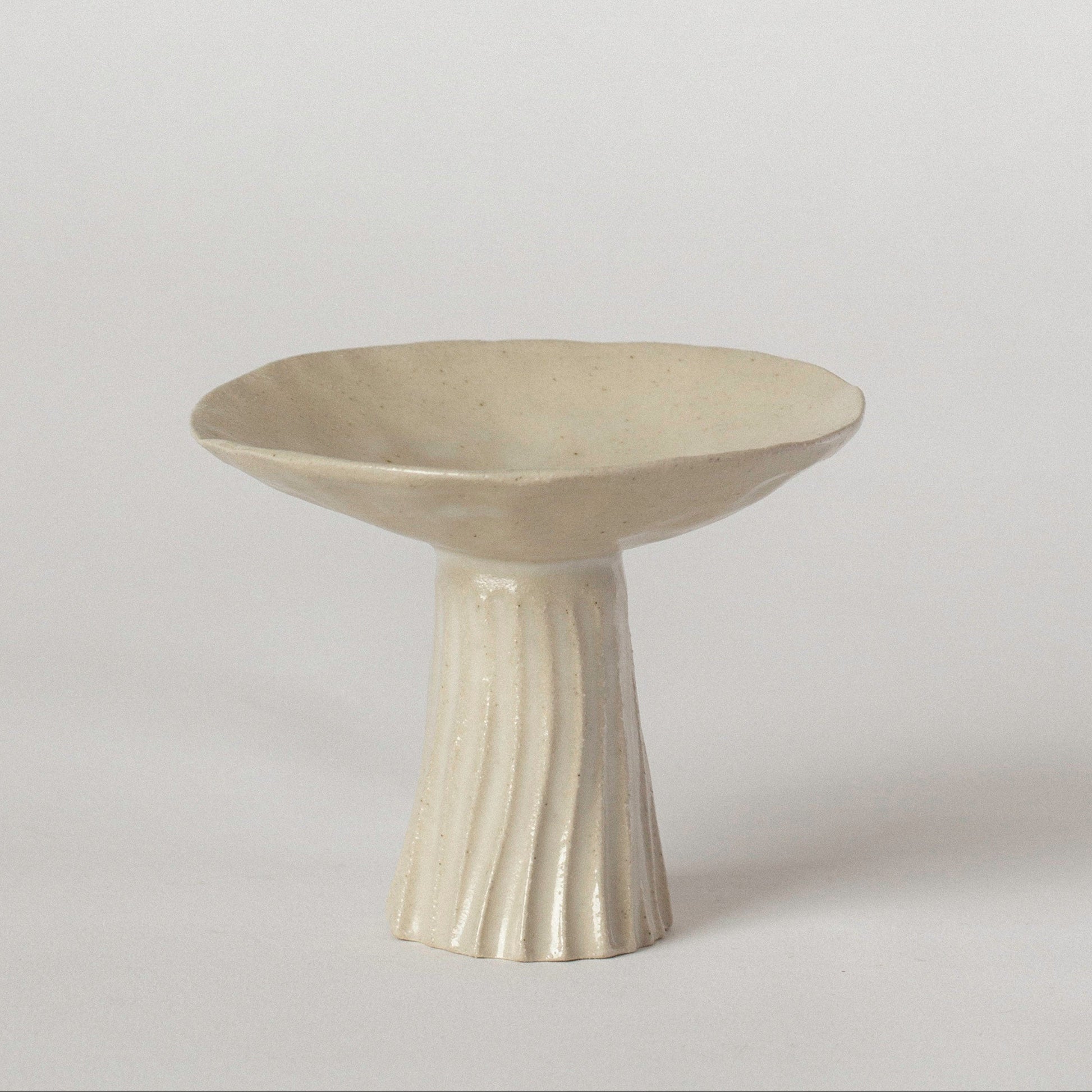 Cream hand pinched and carved incense holder on a white background 